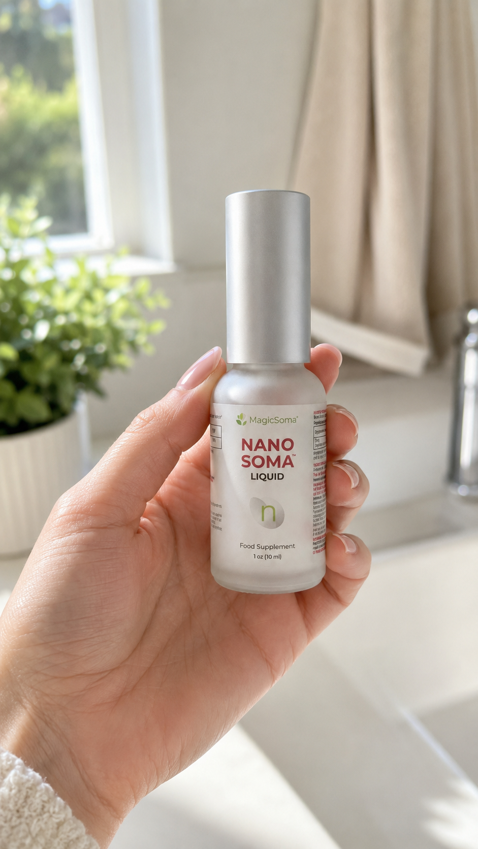 Hand holding Nano Soma Liquid bottle near a bright window with greenery