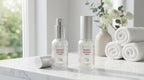 Two Nano Soma Liquid bottles on marble surface with white roses and towels